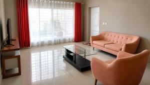 a living room with a couch and a glass table at Milestone Villa in Antananarivo