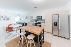 a kitchen with a table and a refrigerator at Joinery North in Charlotte