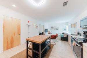 a kitchen and living room with a table at Joinery North in Charlotte +9 photos