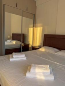 two towels sitting on top of a white bed at JoHa Stay in Bar +13 photos