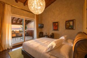 a bedroom with a large bed and a large window at Quercia Belvedere Relais in Bardolino +248 photos