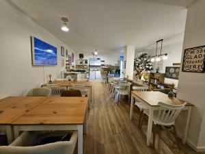 a restaurant with tables and chairs and a kitchen at Farol Guesthouse in Angra do Heroísmo
