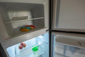 an open refrigerator with its door open and food inside at Escape Turquesa in Los Algodones