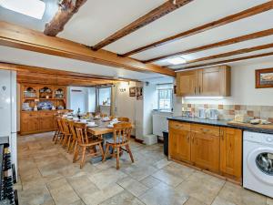 a kitchen with a table and chairs in a room at 6 Bed in Filey oc-94524 in Reighton