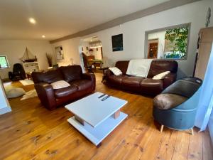 a living room with a couch and a table at La grange de Moli in Vigeois