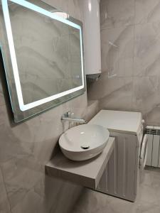 a white bathroom with a sink and a mirror at Fontanka Apartment in Fontanka +17 photos