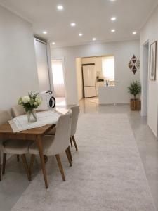 a dining room with a wooden table and chairs at Apart Portakal Çiçeği in Kaş +5 photos