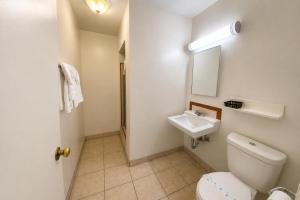 a bathroom with a toilet and a sink at Santa Fe Motel Tehachapi by Hotel O in Tehachapi