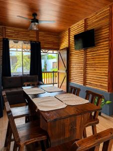 a dining room with a table and a couch at Cabaña Cadete in San Pedro