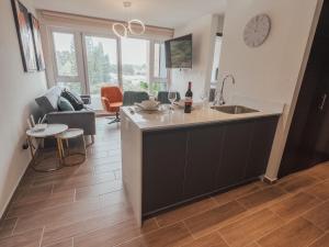 a kitchen and living room with a sink and a table at Marias Apartment Parque Mateo in El Rodeo