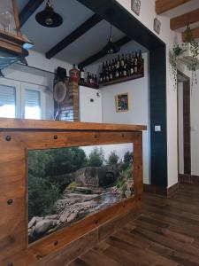 a large tv in a room with a painting on the wall at La Era de Sandra in Sonseca
