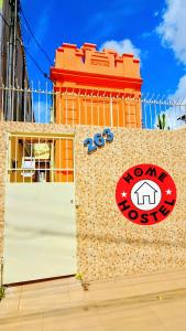 a brick wall with a door in front of a building at Home Hostel Maceió in Maceió +16 photos