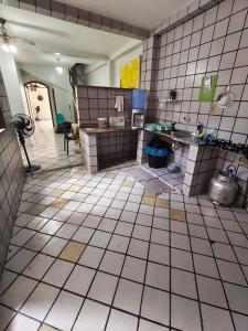 a kitchen with a tiled floor at durmaaquislz2 in São Luís