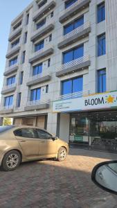 a car parked in front of a building at Maison Eleve Residency in Lahore