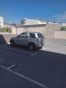 a silver suv parked in a parking lot at Splendide, FACE MER avec place de parking PRIVEE in Berck-sur-Mer
