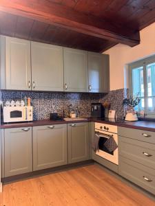 a kitchen with white cabinets and a stove top oven at Drevenica Kráľova in Šumiac