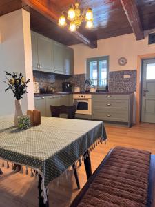 a kitchen with a table and a dining room at Drevenica Kráľova in Šumiac