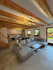 a living room with a couch and a table at MB House Sarbinowo in Sarbinowo