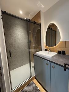 a bathroom with a shower and a sink and a mirror at Appartement neuf & élégant- Centre Lorient in Lorient +23 photos