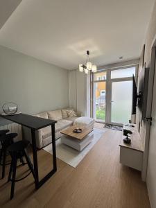 a living room with a couch and a table at Appartement neuf & élégant- Centre Lorient in Lorient