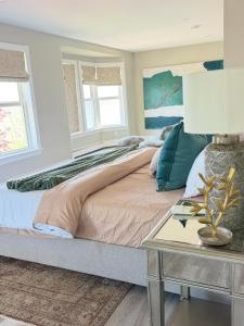a bedroom with a large bed and a table at luxury Beachfront Home With Private Beach Access in Charlottetown