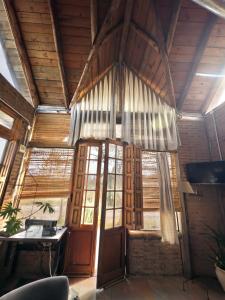 a room with a large window and a desk at Arrullo del viento in Villa Yacanto