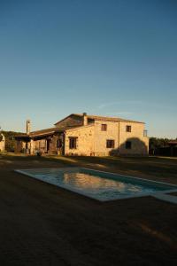 a building with a pool of water in front of it at Mas Furriol in Caldes de Malavella