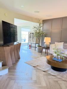 a living room with a couch and a tv at luxury Beachfront Home With Private Beach Access in Charlottetown