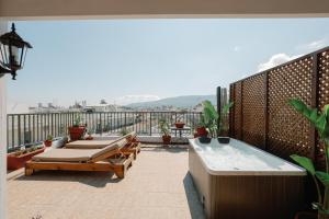 a balcony with a hot tub and a hot tub at Skyloft - Rooftop Jacuzzi & Sea View - Central Kos in Kos