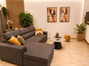 a living room with a couch and a table at Belvedere Penthouse Suite in Tríkala