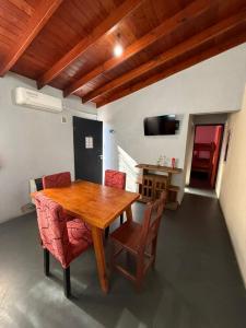 a wooden table and chairs in a room at Romedeptos II in Merlo +9 photos