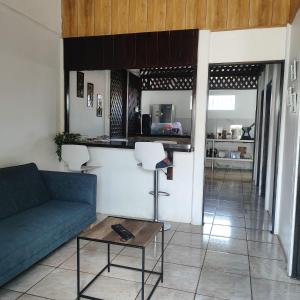 a living room with a couch and a table at Casa KAFRA in Hone Creek