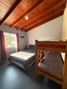 a bedroom with two bunk beds and a window at Romedeptos II in Merlo