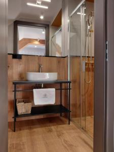 a bathroom with a sink and a shower at Apartamenty Etno Pieniny in Jaworki +40 photos