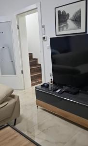 a living room with a large flat screen tv at Villa Aqua Tuzla in Drenovik