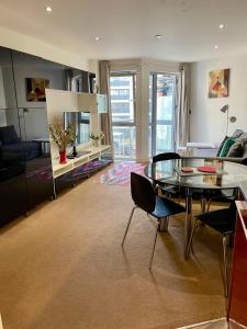 a living room with a glass table and chairs at Marsh House in Bristol