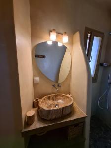 a bathroom with a large wooden sink with a mirror at ACHERONAS Residences in Serifos Chora +34 photos