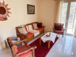 a living room with a couch and a table at Thanasis house in Dimitsana