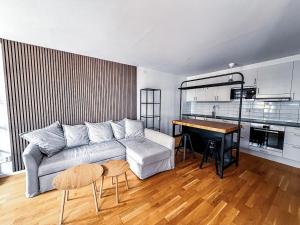 a living room with a couch and a table at Apartment in Höganäs