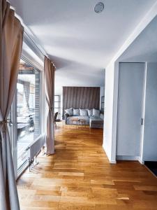 a living room with a couch and a large window at Apartment in Höganäs