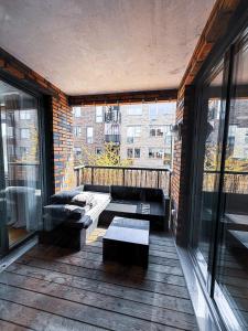 a balcony with a couch and a table on a building at Apartment in Höganäs +8 photos