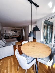 a living room with a wooden table and chairs at Apartment in Höganäs