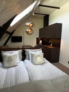 a bedroom with two beds with white pillows at Ludvigsdals Gård in Ystad