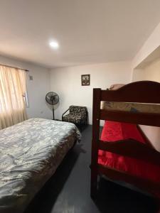 a bedroom with a bed and a fan at Romedeptos I in Merlo