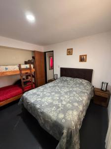 a bedroom with a large bed and a bunk bed at Romedeptos I in Merlo