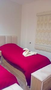 a bedroom with a large bed with a red blanket at Karak Castle House in Kerak