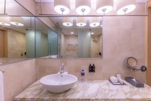 a bathroom with a sink and a large mirror at Barceló México Santa Fe in Mexico City