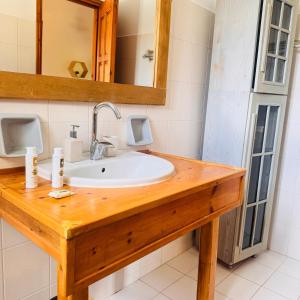 a bathroom with a sink and a mirror at Christina's Sea View House in Yénion +45 photos