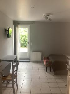 a room with a bed and a table and a window at Chez titi et carole in Dissay-sous-Courcillon