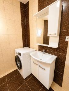 a bathroom with a washing machine and a sink at Lake and Mountain Hideaway in Ohrid +30 photos